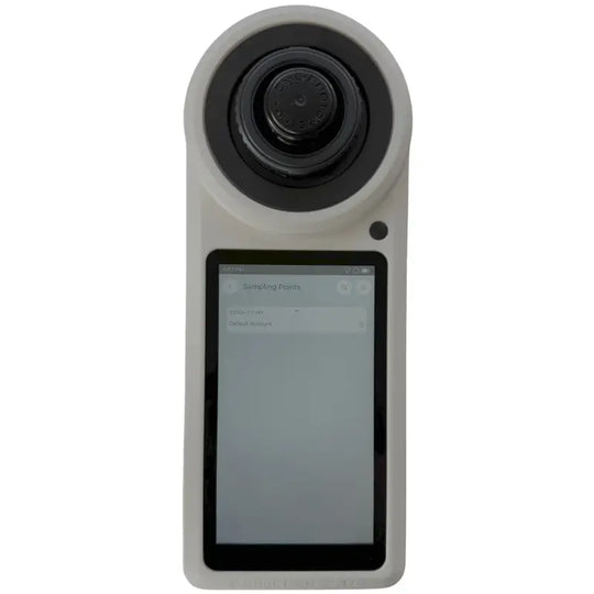 Handheld digital camera with a circular lens and rectangular touchscreen display.