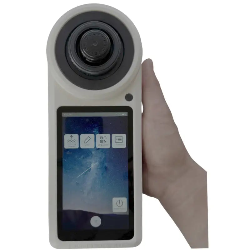 Handheld digital refractometer with a circular lens and touchscreen display.