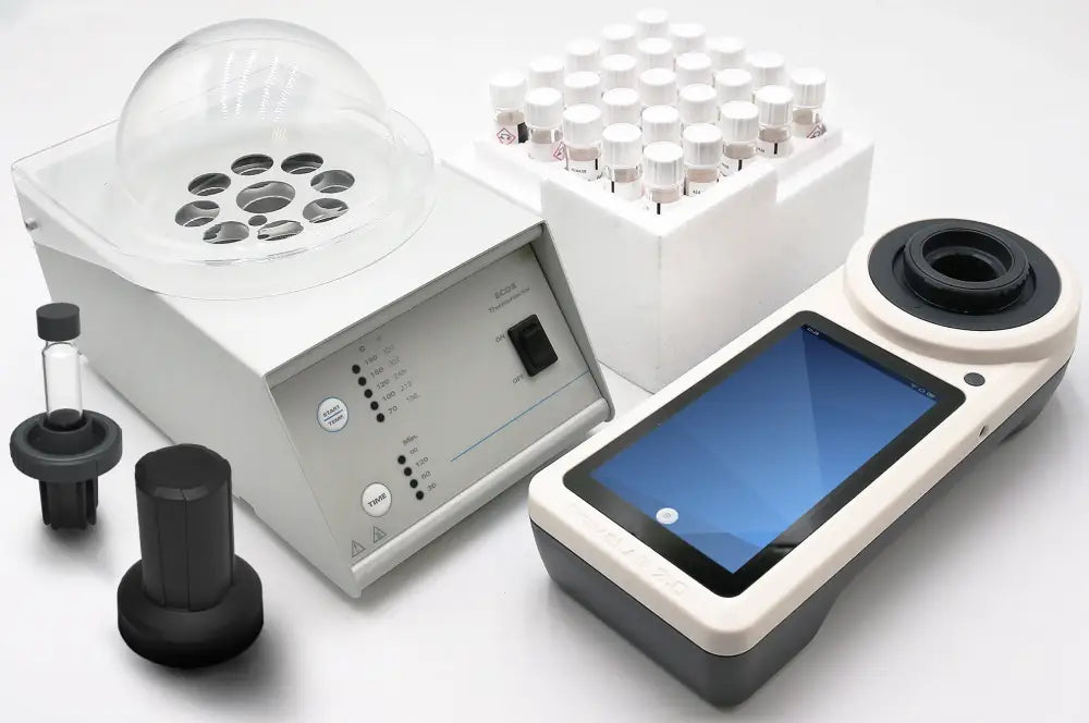 Laboratory centrifuge with accompanying accessories and a digital device.